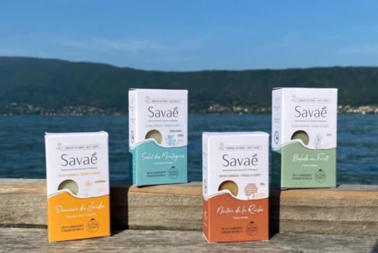 Savons à froid fabriqués par savaé dans leur emballage en carton devant le lac d'Annecy. photo prise du bord du lac à Veyrier du lac. 100% naturel